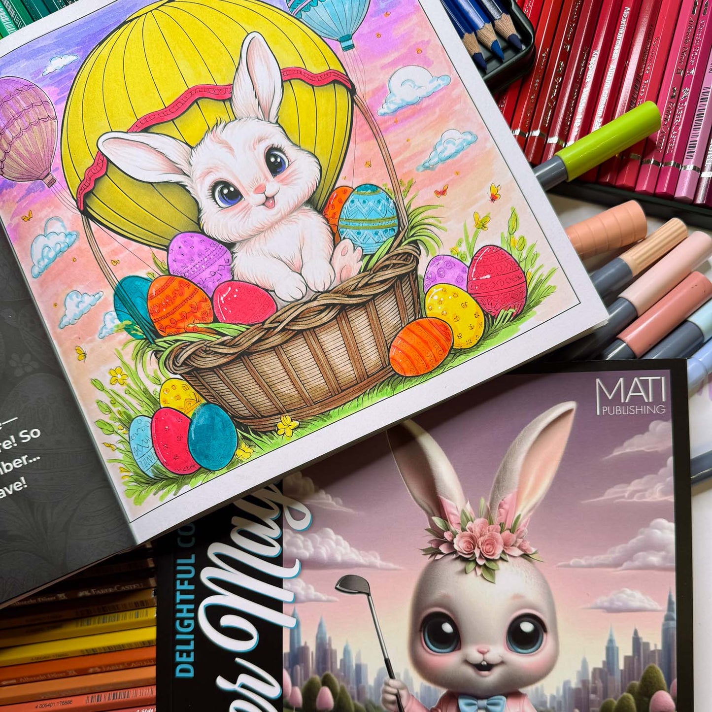 Coloring in progress — bunny in hot air balloon basket with decorated eggs and pencils — from Easter Magic (ages 4–8) | MATI Publishing